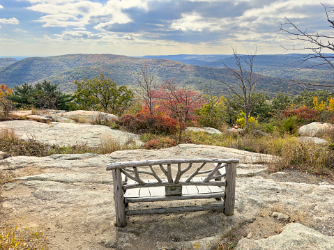 Empty bench in front of beautiful landscape from the top of Bear Mountain in New York
