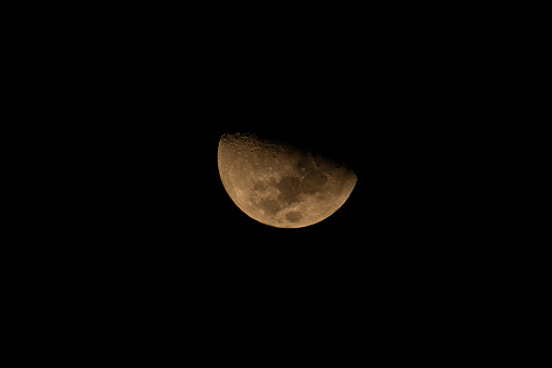 Half moon with the ground in front of the spire of the mosque