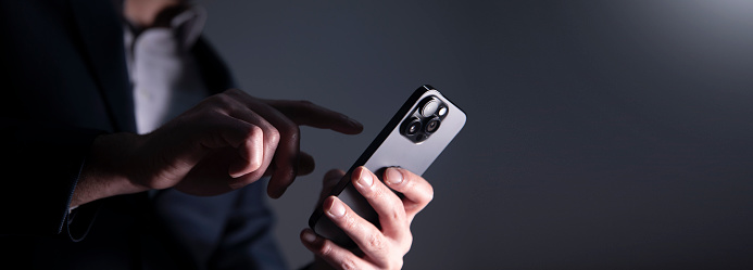 Close-up photo of male hands with smartphone