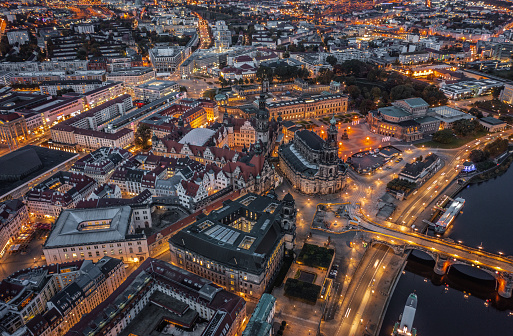 Aerial view of Dresden skyline at dawn. Illuminated Katholische Hofkirche, Frauenkirche, Zwinger, Elbe river and Semper Opera House. Germany - Saxony