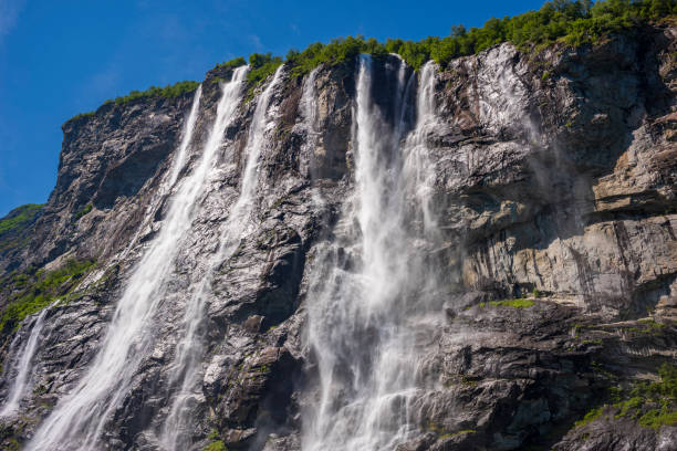 The Seven Sisters waterfall gets its name from, the seven separate streams, the tallest measures 250 meters. The waterfall is located at Geirangerfjord between Geiranger and Hellesylt.