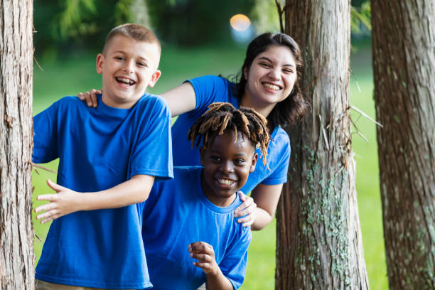 istock Boy with camp counselor in park at summer camp 1910259962