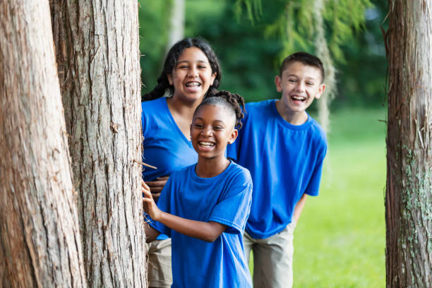 istock Three multiracial children at summer camp in park 1910260154