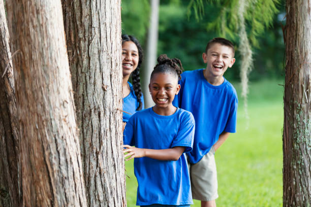 istock Three multiracial children at summer camp in park 1910260160