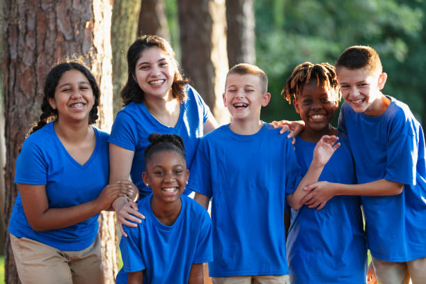 Multiracial children with counselor at summer camp