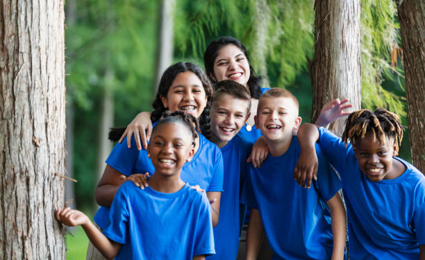 istock Multiracial children with counselor at summer camp 1910260375