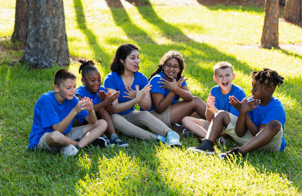 istock Multiracial children with counselor at summer camp 1910261596
