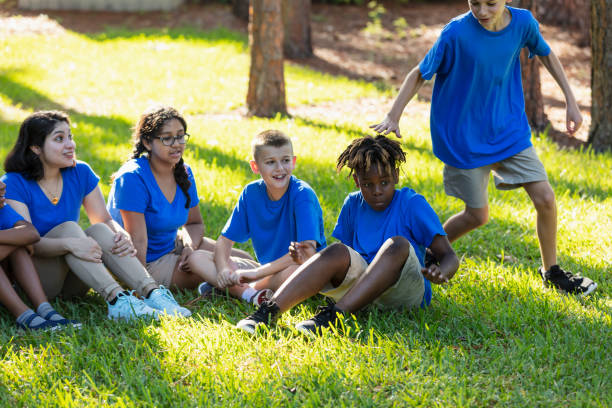 istock Multiracial children with counselor at summer camp 1910261609
