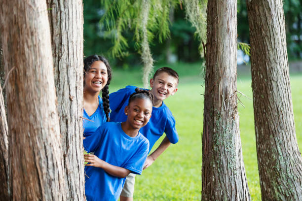 istock Three multiracial children at summer camp in park 1910263192