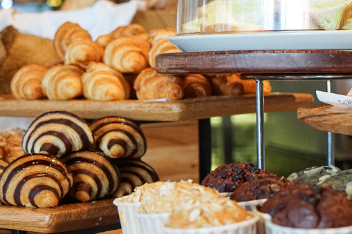 Breads, cupcakes and pastries at a buffet spread
