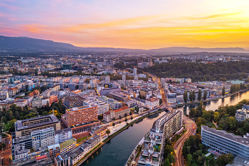 Geneva, Switzerland skyline view from over the river after sunset.