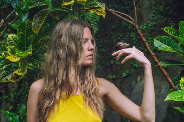 istock young woman with big snail 1910312163
