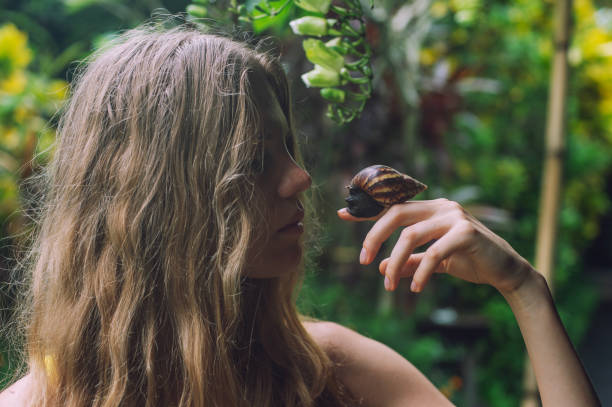 istock young woman with big snail 1910313199