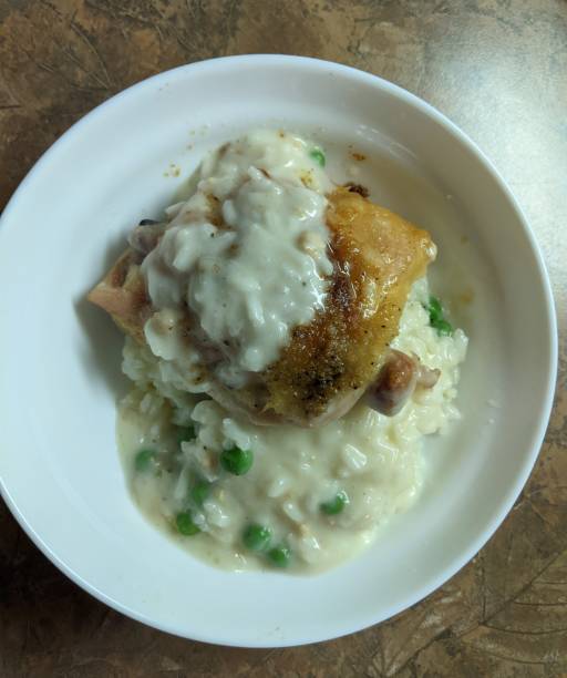istock Roasted Chicken Thigh with Creamy Risotto and Peas 1910323314