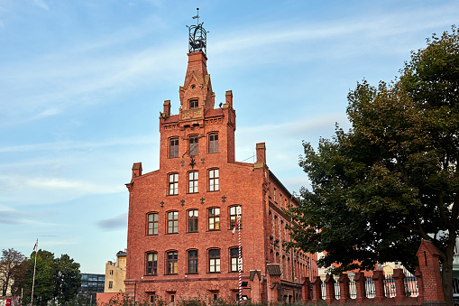 A historic, red brick building in the center of Poznan, Poland