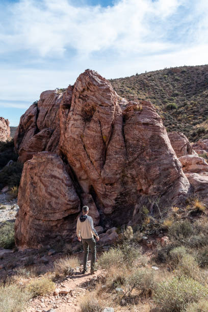istock Person standing in front of big rock 1910379202