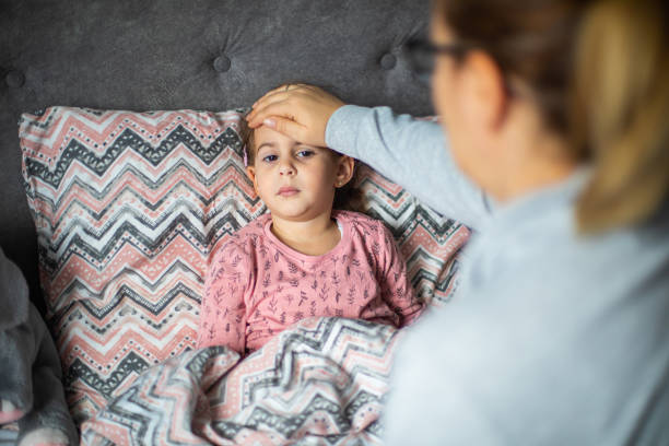 istock Caring mother measuring her daughter temperature 1910403948