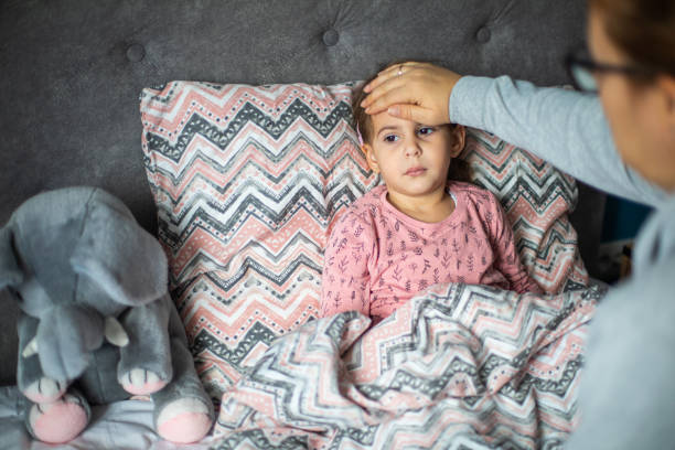 istock Caring mother measuring her daughter temperature 1910404462