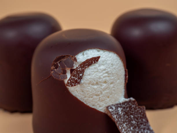 istock Marshmallows in chocolate glaze on an orange background. 1910405497