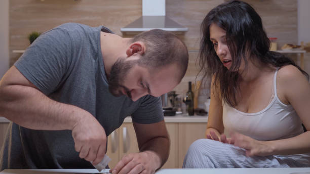 istock Couple of addicts at home 1910406021