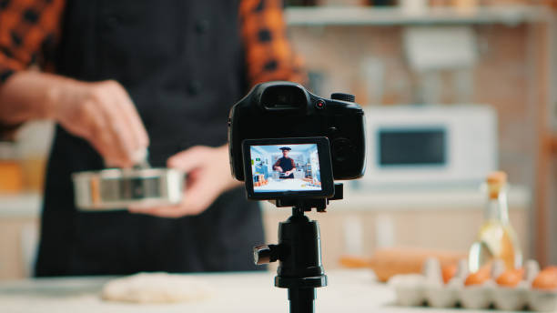 istock video camera filming man in kitchen 1910426994