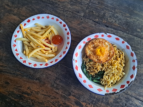 Delicious Fried Noodles Egg And French Fries. Mi Goreng Dan Kentang Goreng. Food Menu.