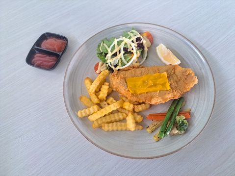 Fish And Chips - Deep Fried Red Snapper Fillet In Crispy Batter, Served With Tar Tar Sauce. French Fries Or And Mixed Salad. Fresh Tea Iced. Food And Drink Menu.