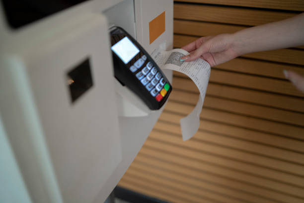 istock Woman using self-service cash register to checkout 1910435630
