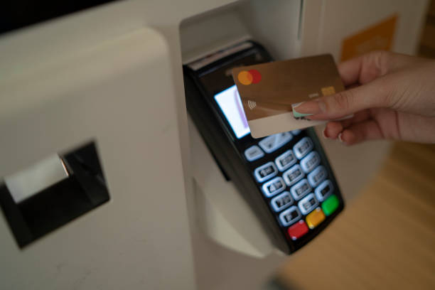 istock Woman using self-service cash register to checkout 1910436173