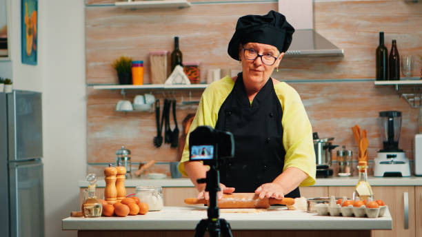 istock Grandmother making cooking vlog 1910437277