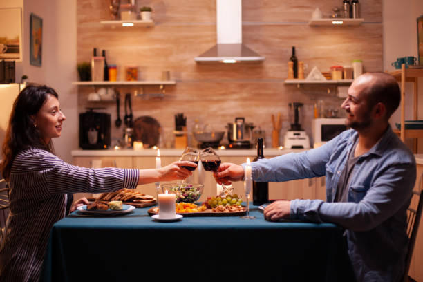 istock Husband and wife holding wine glasses 1910448629