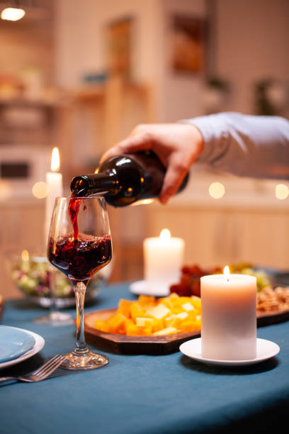 istock Close up pouring wine in glass 1910454572