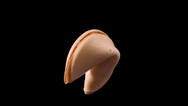 Fortune cookies rotate on a black background.