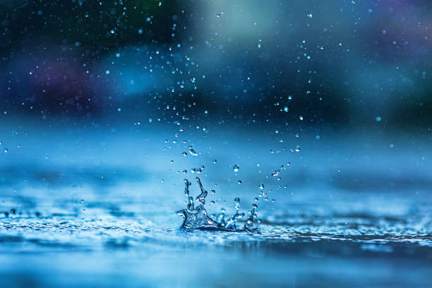 istock Raindrop falls in puddle. Rain. Splashes of water 1910463018