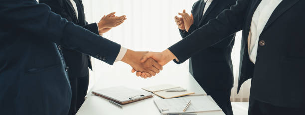 istock Two business executive shake hand in boardroom for merger and acquisition. Shrewd 1910467703