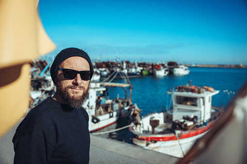 Fisherman portrait at harbor: fishing industry in Italy, in the Mediterranean Sea