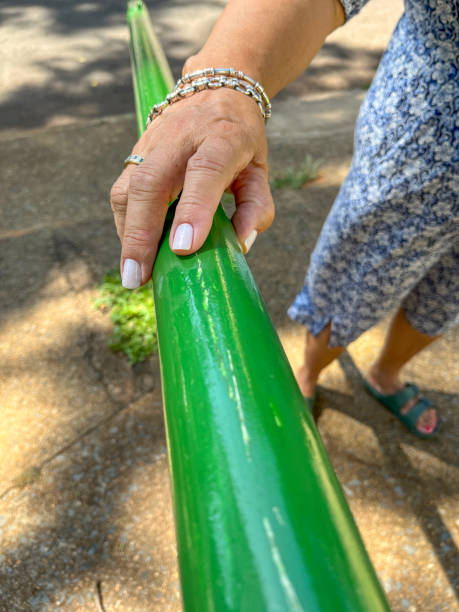 Senior woman using handrail to ascend steps