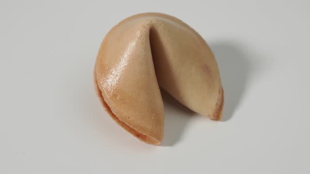 Fortune cookies rotate on a white background.