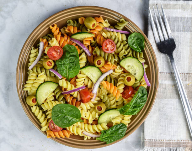 istock tri color rotini pasta salad with spinach 1910498555