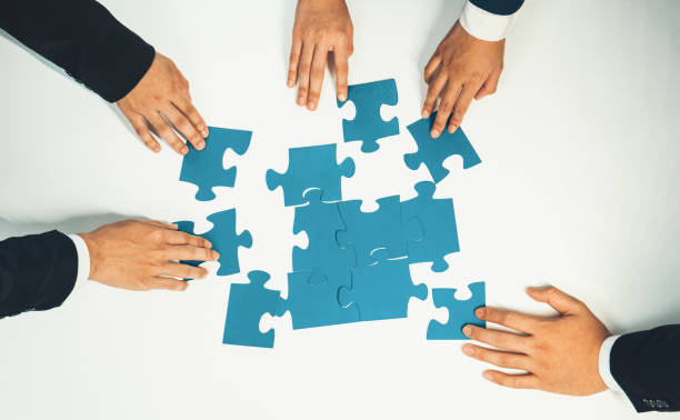 istock Top view panorama banner of business team assembling jigsaw puzzle. Shrewd 1910503286
