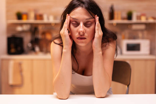 istock Woman with headache sitting on chair 1910504307