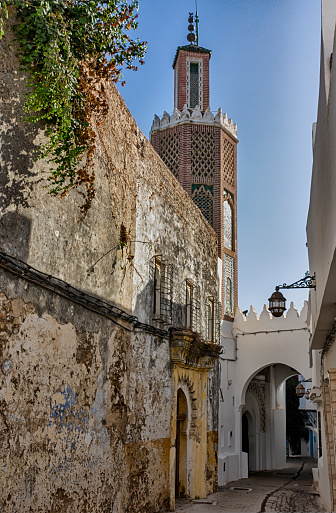 A lonely street with a passage under the building with the entrance to the Jamaa lkasba mosque, in the kasbah of the medina of Tangier, Morocco