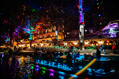 Crowded Riverwalk with colorful christmas lights. San Antonio, Texas, USA