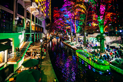 Crowded Riverwalk with colorful christmas lights. San Antonio, Texas, USA