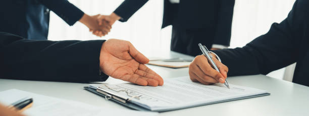 istock Two business executive shake hand in boardroom for merger and acquisition. Shrewd 1910531711