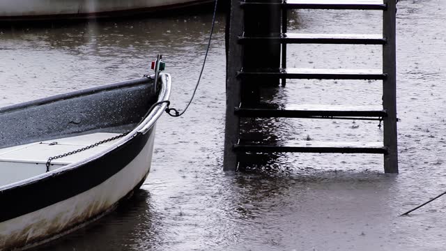 A Small Row Boat Moored on a Rainy Day in Tigre, Buenos Aires Province, Argentina. Close Up. 4K Resolution.