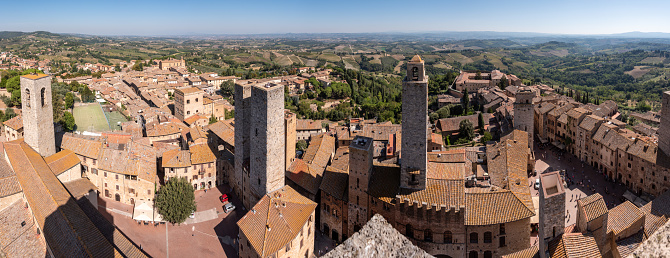 Wide panoramic view over downtown San Gimignano, Torri dei Salvucci and Torre Rognosa in the center, seen from Torre Grosso, Italy