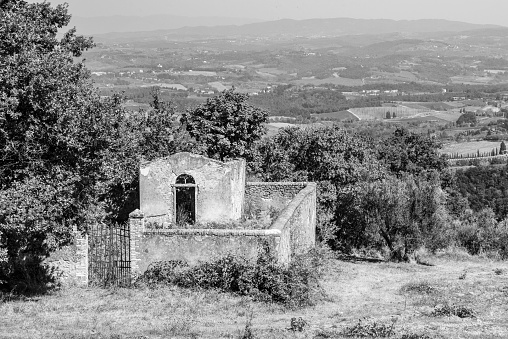 A small derelict cemetery near the Cellole monastery in the beautiful landscape of the Tuscany, Italy