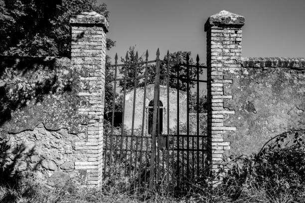 a small derelict cemetery near the cellole monastery in the beautiful landscape of the tuscany - lock door horror gate imagens e fotografias de stock