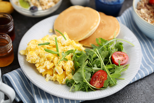 Healthy breakfast with scrambled eggs and crispy toasted bread